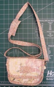 Completed DIY Clutch bag on a green cutting mat