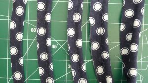 piping of increasing size sew with a navy blue fabric with white dots