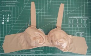 Light copper Classic Bra showing cups, band and fabric straps attached (on a green background)