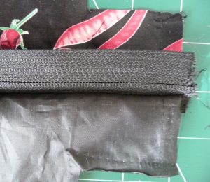 PInning layers together: black & pink exterior (top), black zipper tape (middle), & black interior (bottom)
