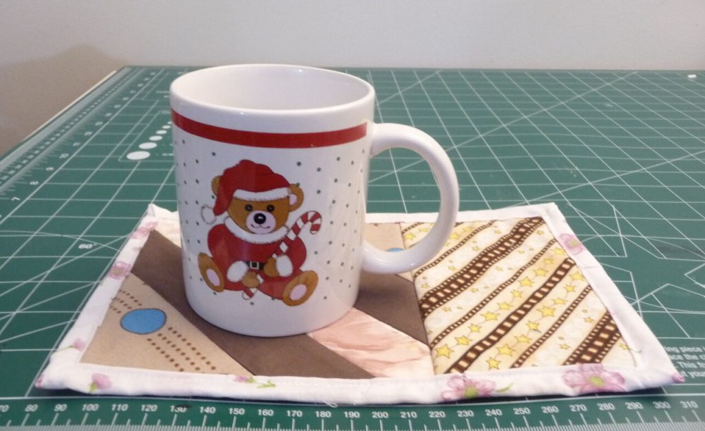 Christmas themed mug on a mug rug with sections for mug and snack 
