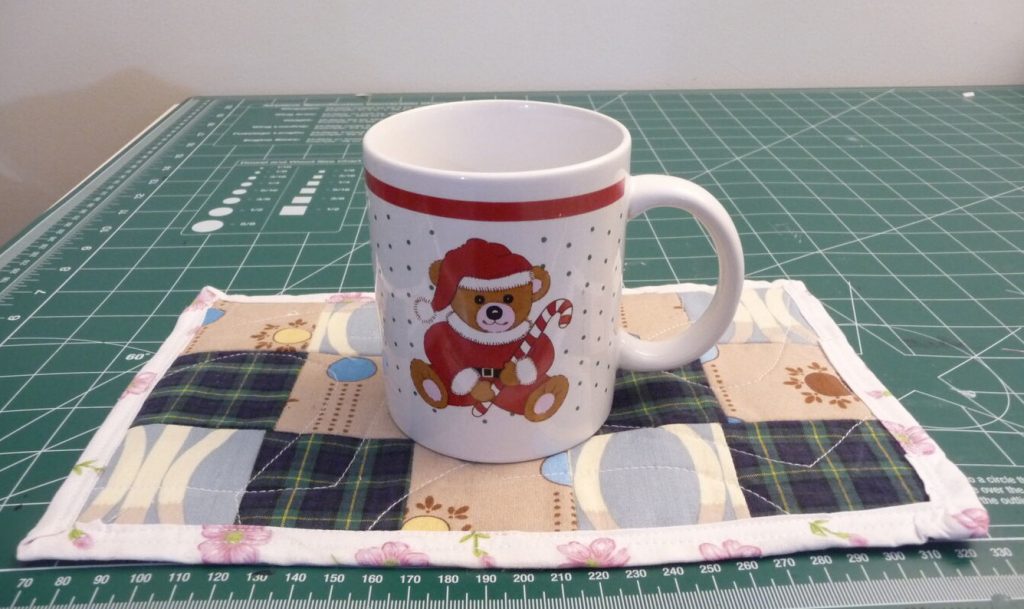 Christmas themed mug on a patchwork mug rug