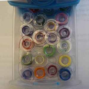 Threaded plastic bobbins in a small drawer