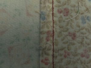Back view of a flat felled seam joining 2 floral fabrics