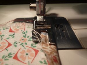 Closeup of sewing a seam in floral fabrics
