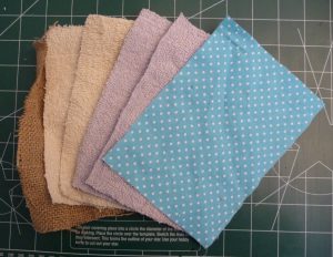 Overlaping rectangles of burlap, old towel, & quliting weight cotton