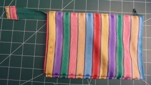 Front view of a zipper pouch with vertical stripes