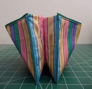 Side view of an open zipper pouch with vertical stripes