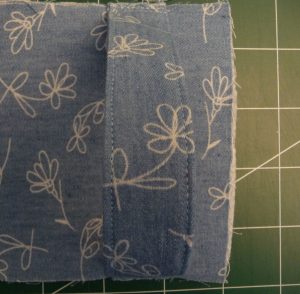Close up of while flowers on the plae blue fabric