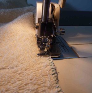 Side cutter foot attached to sewing machine for sewing towel
