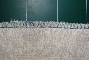 Front of towel edge after zigzag and straight stitch with side cutter foot